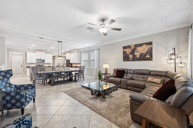 living room with light tile patterned floors, crown molding, and ceiling fan