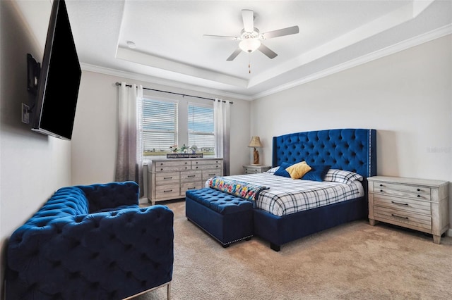 bedroom featuring a raised ceiling, light colored carpet, and ceiling fan