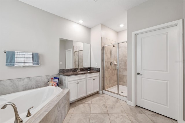 bathroom with vanity, tile patterned flooring, and shower with separate bathtub