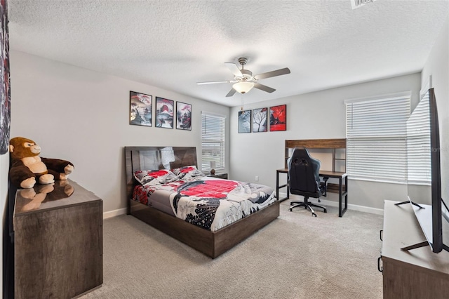 carpeted bedroom with a textured ceiling and ceiling fan