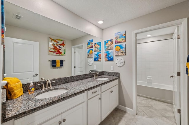 bathroom with vanity, shower / bathing tub combination, and a textured ceiling