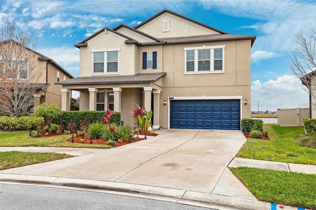 view of front of property featuring a garage and a front lawn