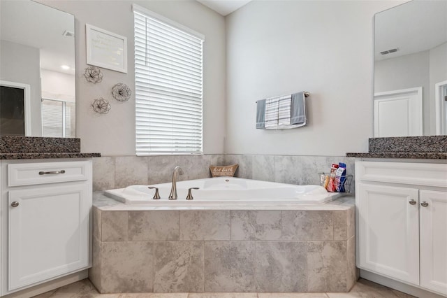 bathroom featuring vanity, a wealth of natural light, and plus walk in shower