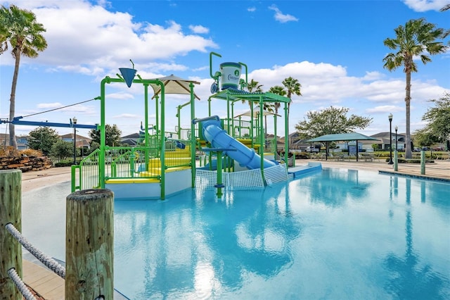 view of swimming pool with a playground