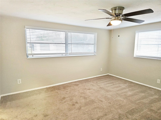 carpeted empty room featuring ceiling fan