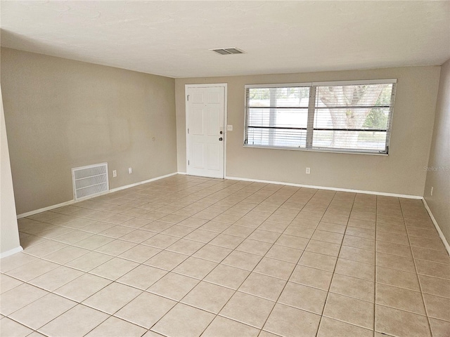 unfurnished room featuring light tile patterned floors