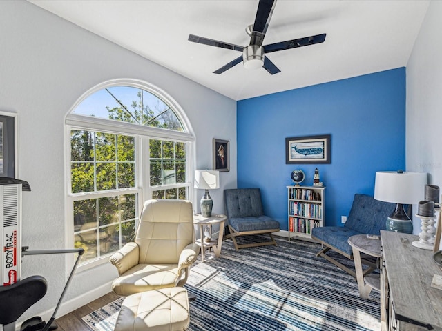 living area with hardwood / wood-style flooring and ceiling fan