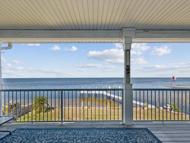 wooden deck with a yard and a water view