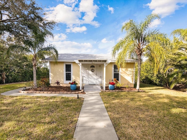 ranch-style home featuring a front yard