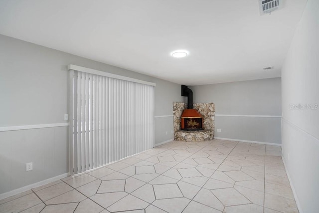 unfurnished living room with a wood stove