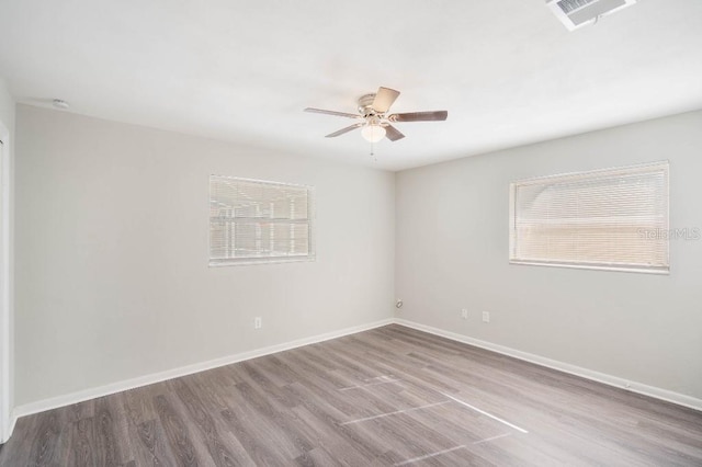 spare room with wood-type flooring and ceiling fan