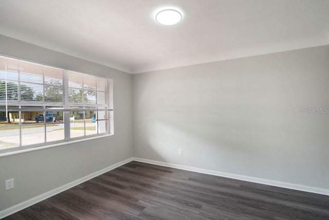 unfurnished room featuring dark hardwood / wood-style flooring