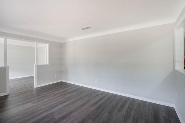 empty room with dark wood-type flooring