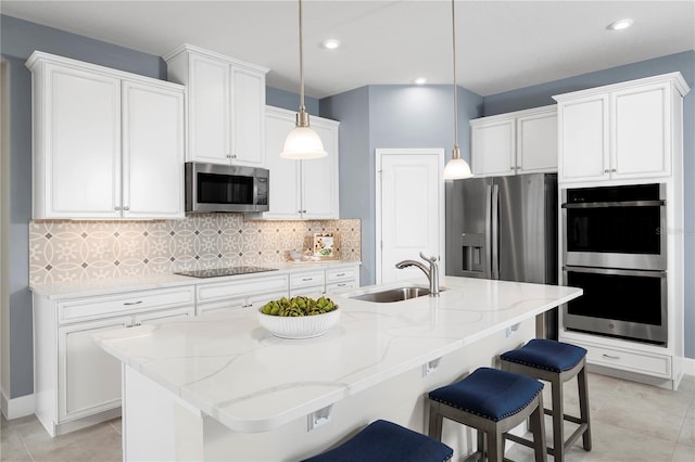 kitchen with sink, white cabinetry, decorative light fixtures, a center island with sink, and appliances with stainless steel finishes