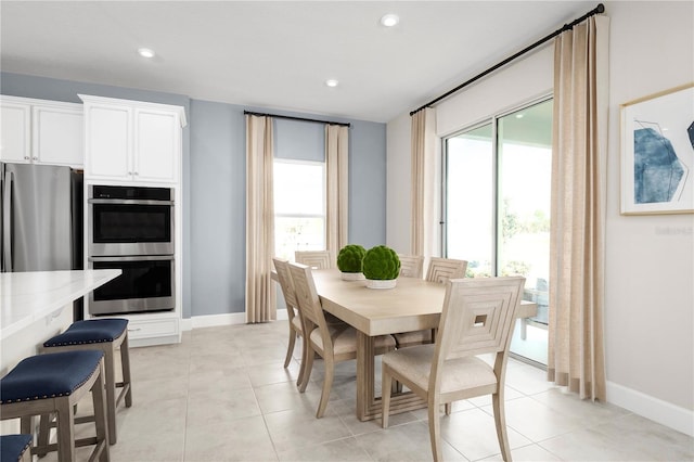 tiled dining room with a wealth of natural light