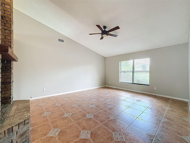 unfurnished living room featuring ceiling fan, tile patterned floors, vaulted ceiling, and a textured ceiling