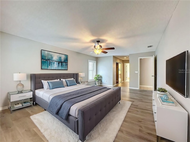 bedroom featuring ceiling fan and light hardwood / wood-style floors