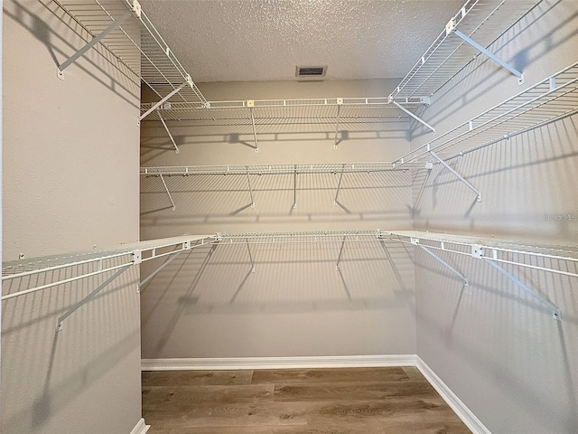 walk in closet featuring hardwood / wood-style flooring