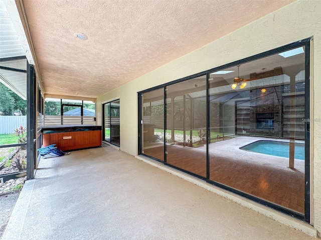 unfurnished sunroom with a fireplace