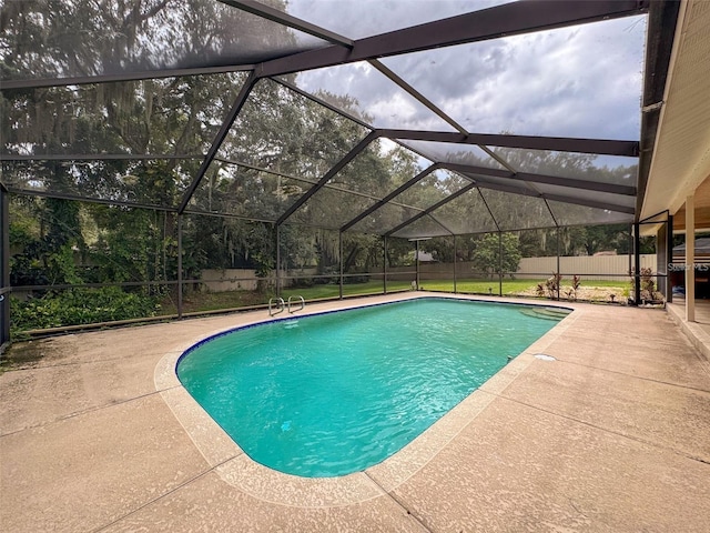 view of swimming pool with a lanai and a patio