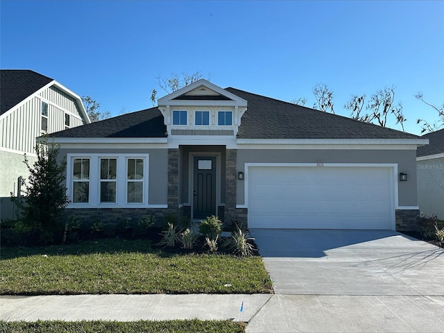 craftsman-style house featuring a garage and a front lawn