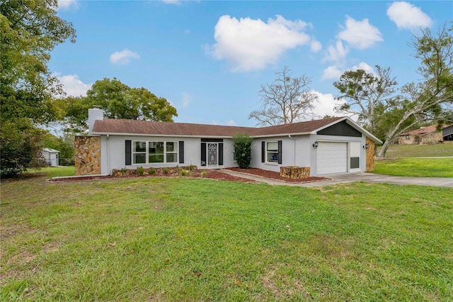 ranch-style home featuring a chimney, an attached garage, concrete driveway, and a front yard