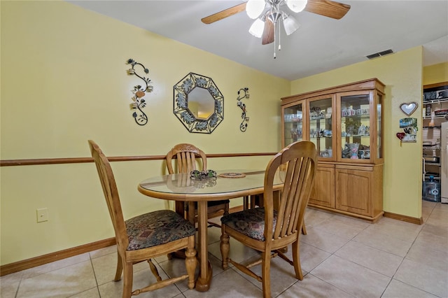 dining room featuring light tile patterned floors, visible vents, baseboards, and ceiling fan