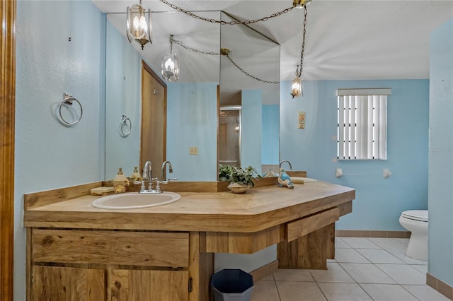 full bath with an enclosed shower, toilet, tile patterned flooring, baseboards, and vanity