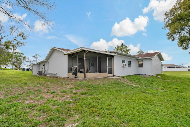 rear view of property featuring central air condition unit, a yard, and a sunroom