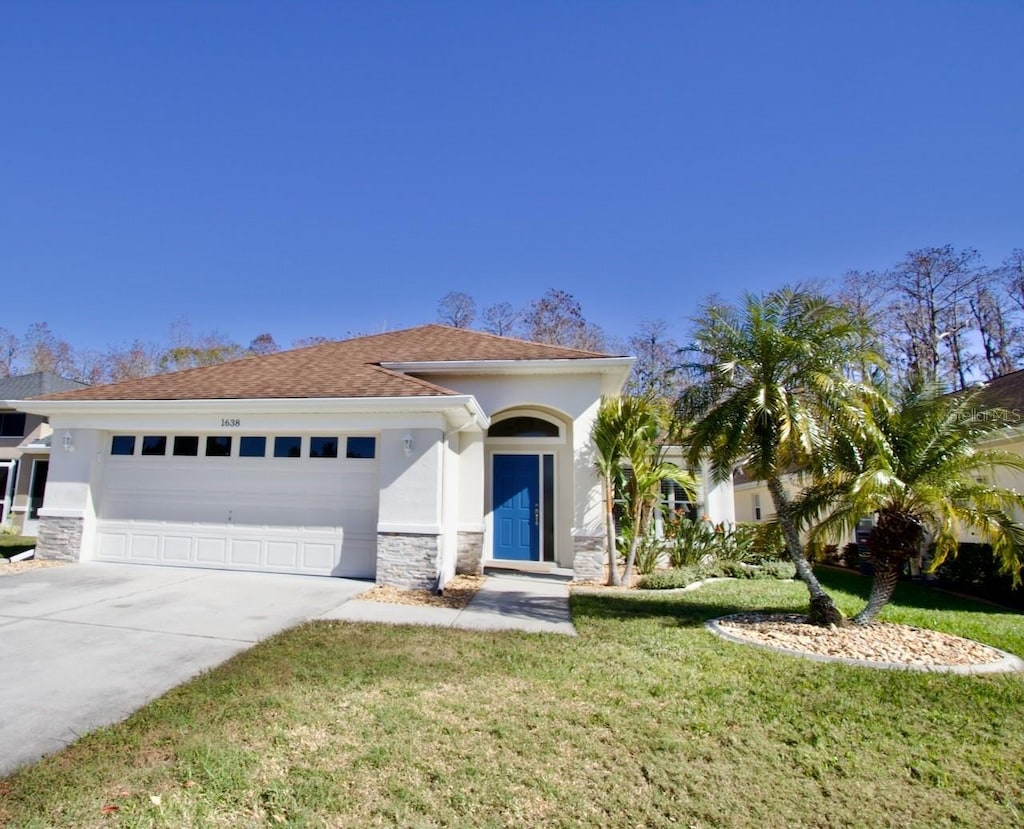 view of front facade with a garage and a front lawn