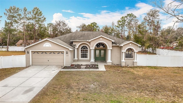 view of front of home with a garage and a front yard