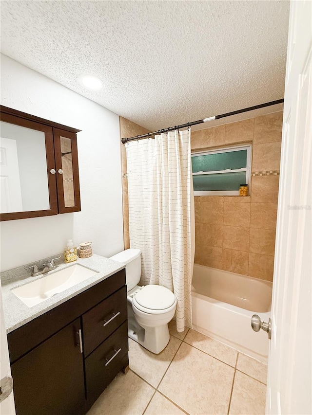 full bathroom featuring tile patterned flooring, vanity, a textured ceiling, toilet, and shower / bath combo with shower curtain