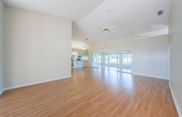 unfurnished living room featuring lofted ceiling, ceiling fan, and light hardwood / wood-style flooring