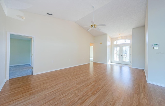 unfurnished room featuring french doors, ceiling fan, high vaulted ceiling, and light hardwood / wood-style flooring