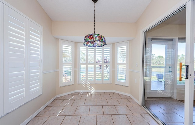 unfurnished dining area with light tile patterned floors