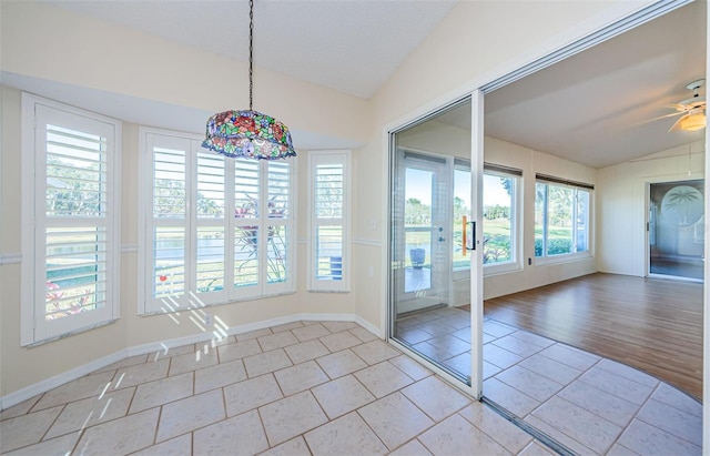 interior space with ceiling fan, lofted ceiling, and a wealth of natural light