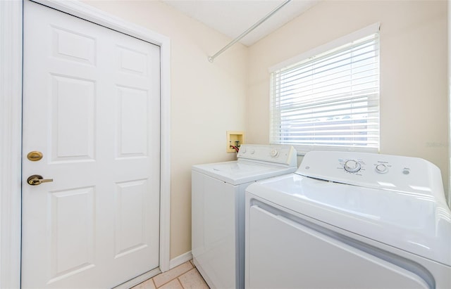 washroom featuring light tile patterned floors and washing machine and dryer