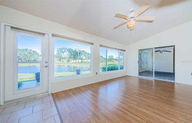 interior space featuring a water view, ceiling fan, and vaulted ceiling