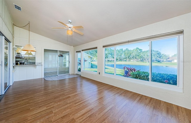 interior space featuring ceiling fan, lofted ceiling, light hardwood / wood-style floors, and plenty of natural light