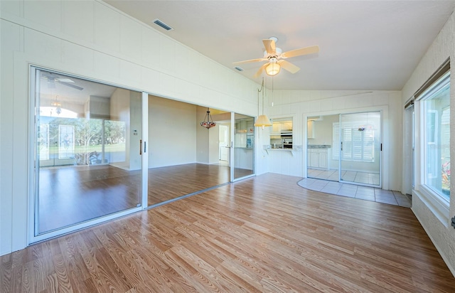 unfurnished sunroom with ceiling fan and lofted ceiling