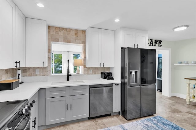 14124 Kulig Ct, Hudson, FL 34667 - kitchen featuring tasteful backsplash, light countertops, gray cabinetry, appliances with stainless steel finishes, and a sink