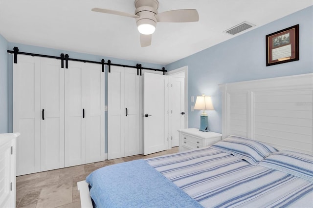 14124 Kulig Ct, Hudson, FL 34667 - bedroom with visible vents, ceiling fan, and a barn door