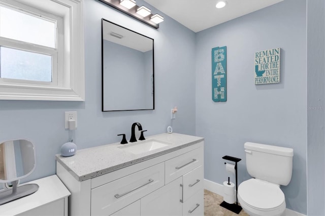 14124 Kulig Ct, Hudson, FL 34667 - bathroom with toilet, vanity, and baseboards
