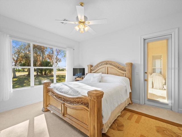 bedroom featuring light colored carpet and ceiling fan