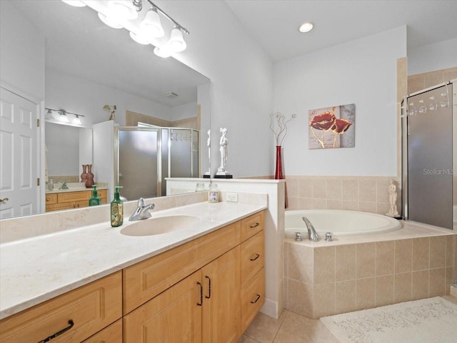 bathroom featuring tile patterned floors, independent shower and bath, and vanity