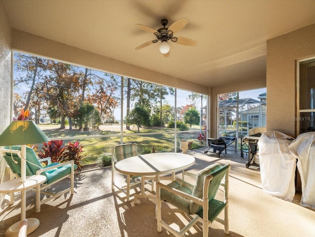 sunroom featuring ceiling fan