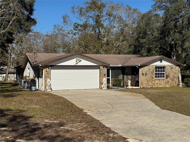 single story home featuring a garage and a front lawn