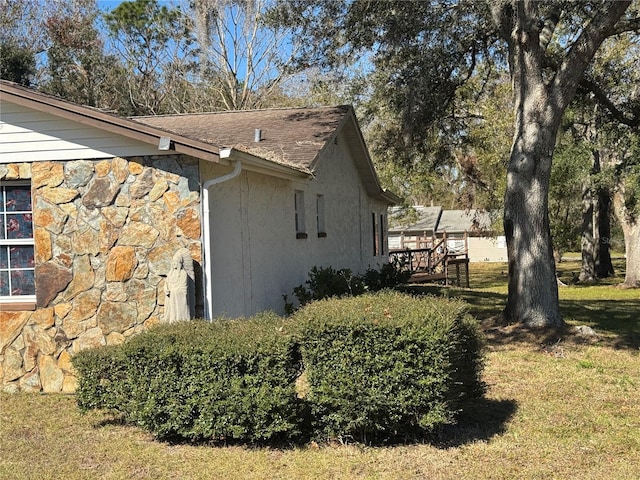 view of property exterior featuring a lawn