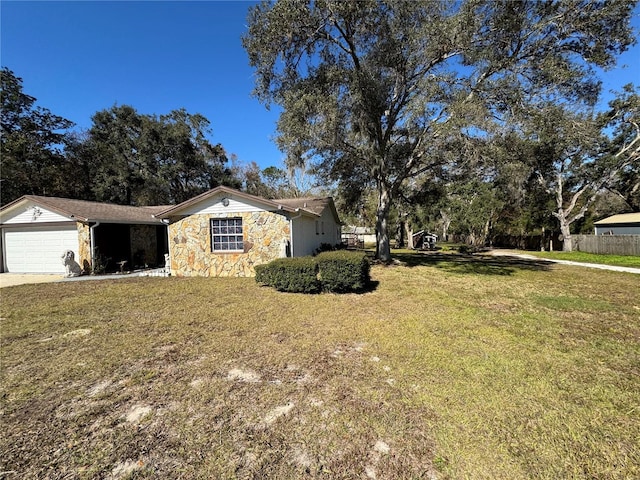 view of front of home with a garage and a front lawn