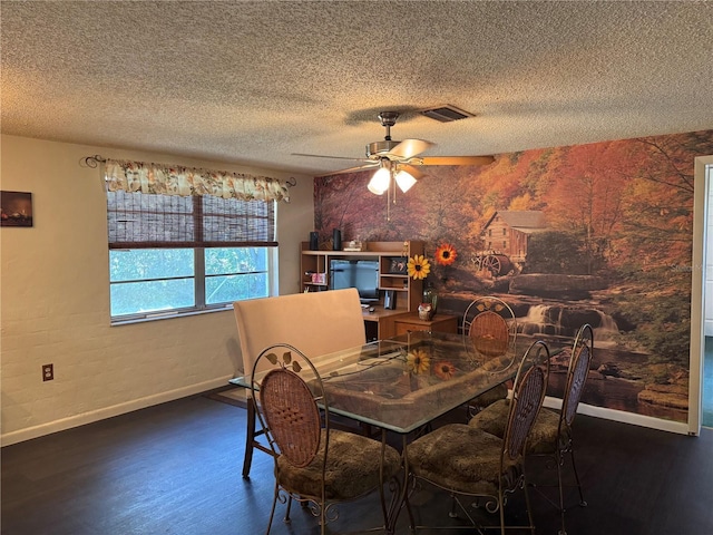 dining space featuring dark hardwood / wood-style flooring, a textured ceiling, and ceiling fan